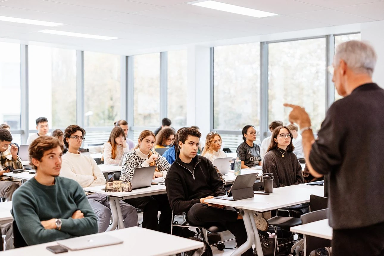 Students learning from a lecturer in a bright university classroom